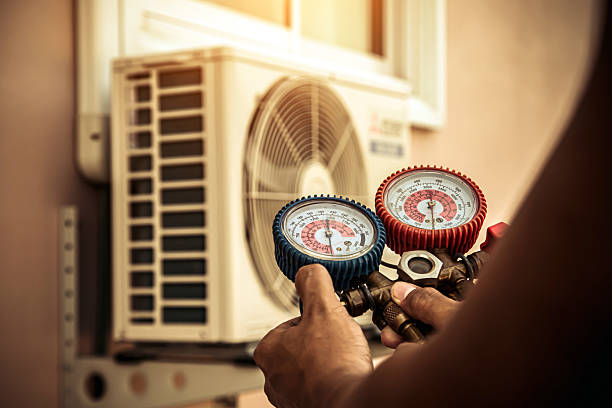 Professional Air Conditioning Service technician working in Versailles, NY
